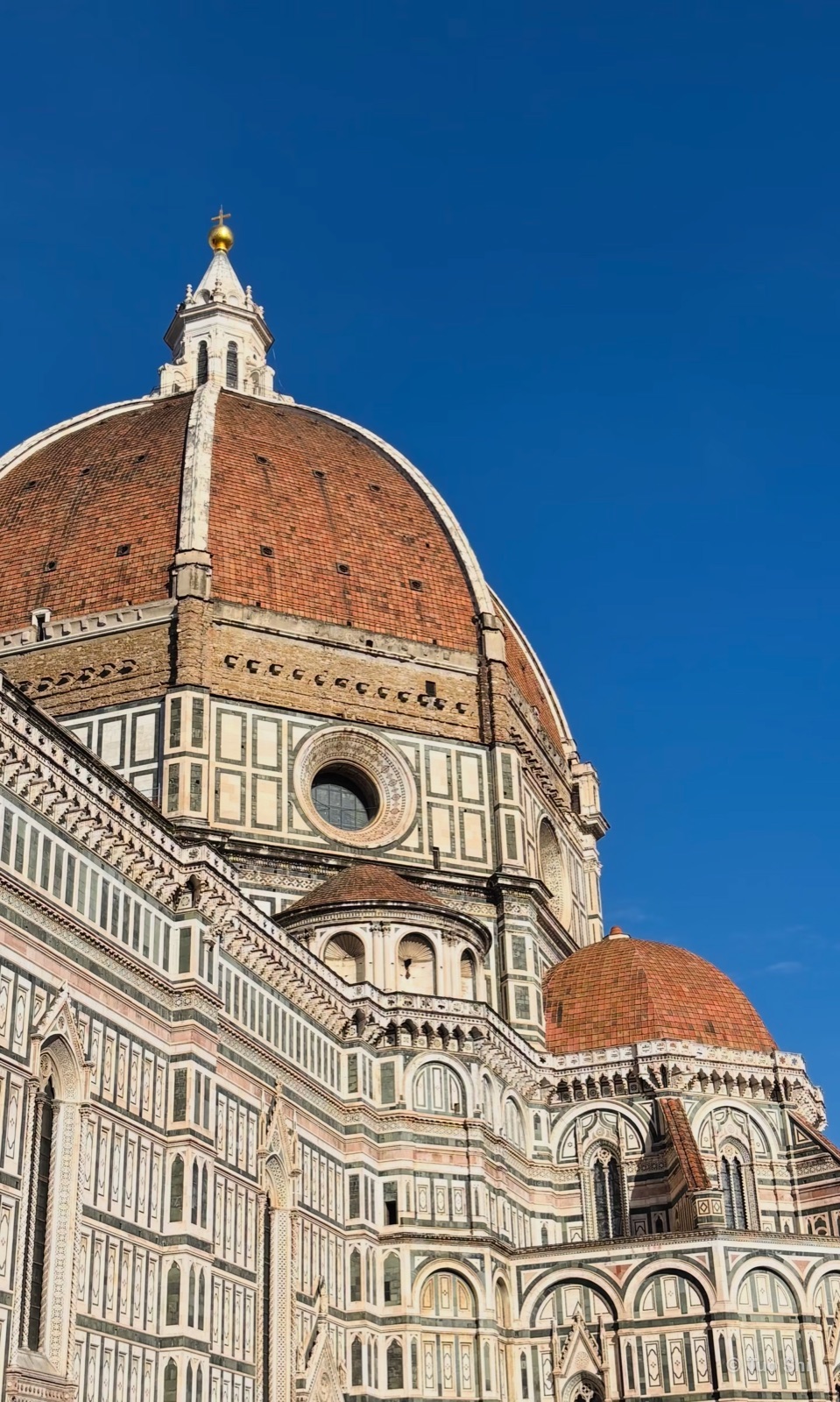 The dome of Florence Cathedral against a clear blue sky