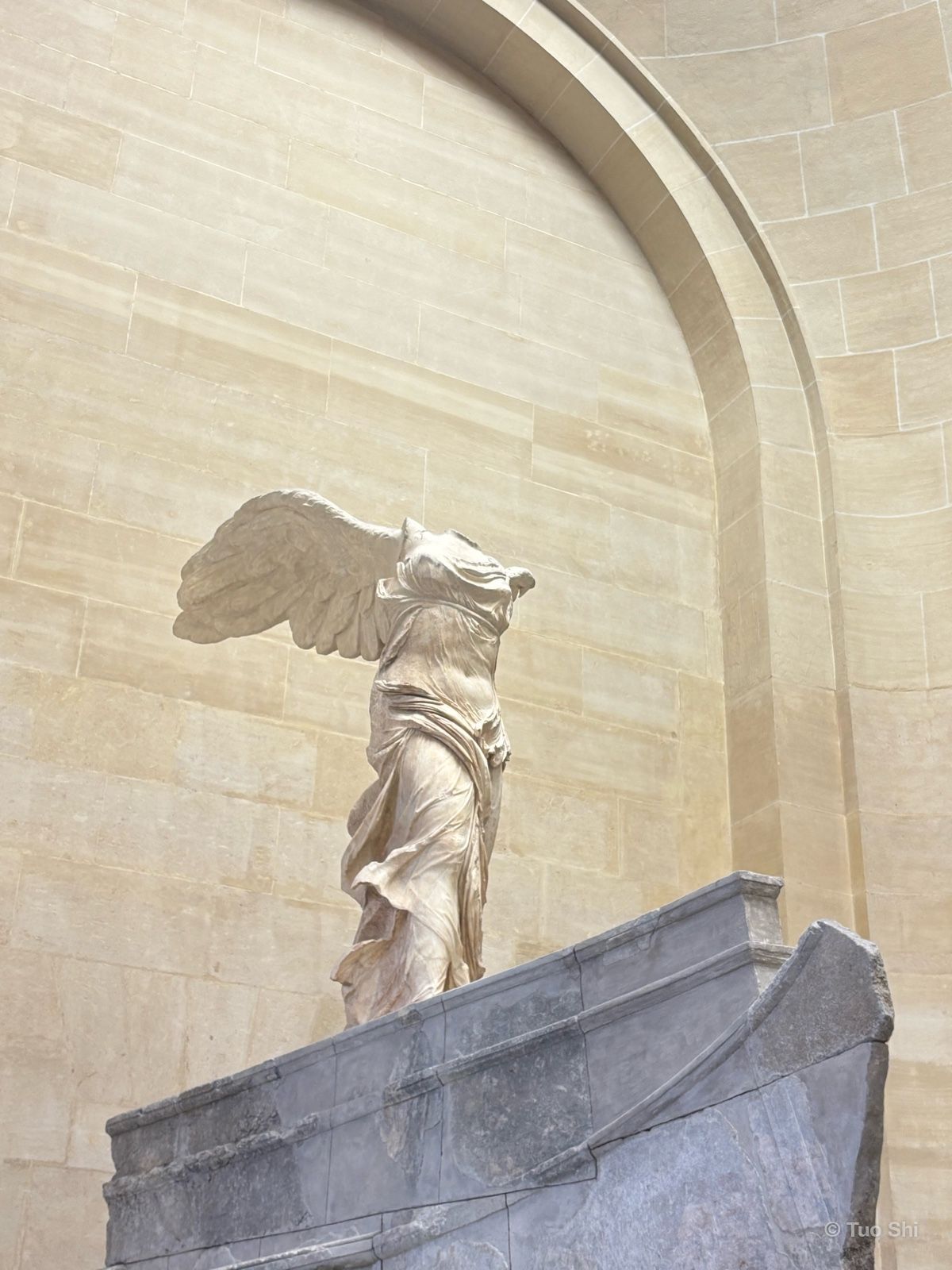 The Winged Victory of Samothrace with outstretched wings on its ship-shaped base