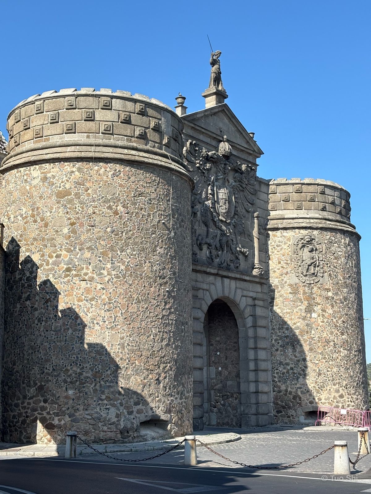 The twin round towers and carved coat of arms of the Puerta de Bisagra city gate